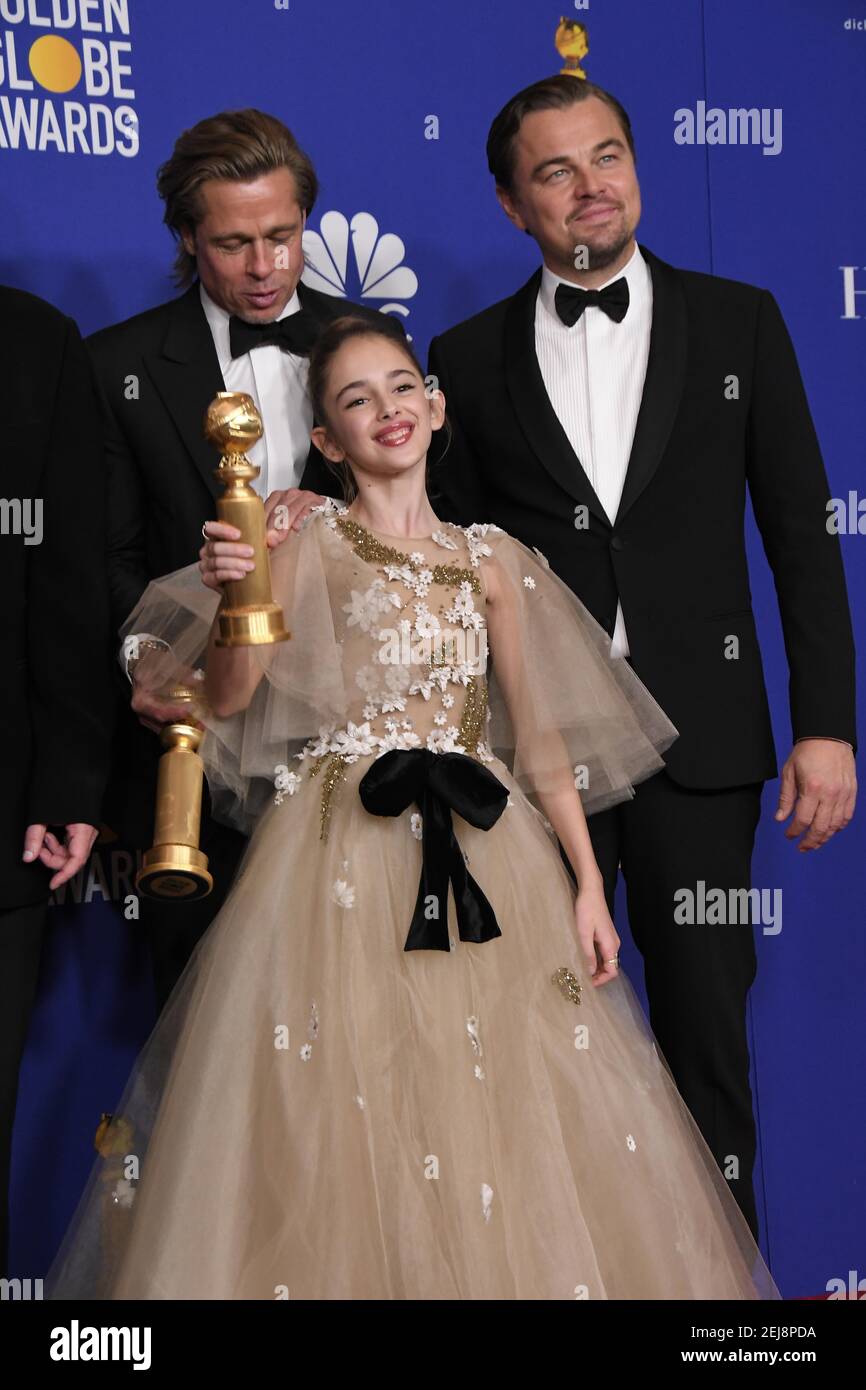 Brad Pitt, Julia Butters and Leonardo DiCaprio pose in the press room
