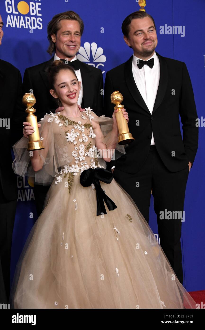 Brad Pitt, Julia Butters and Leonardo DiCaprio pose in the press room
