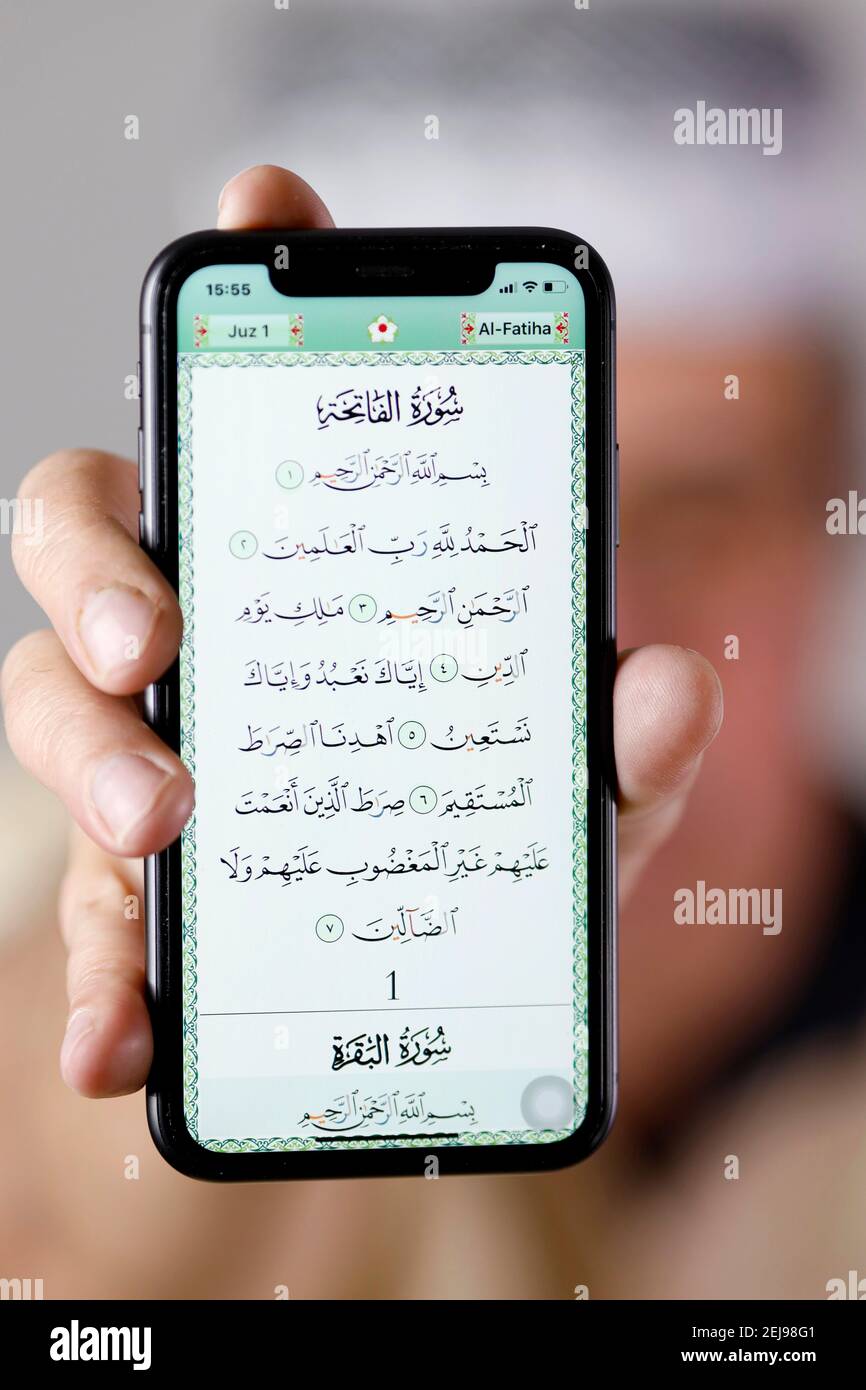Man showing an electronic quran on a smartphone Stock Photo