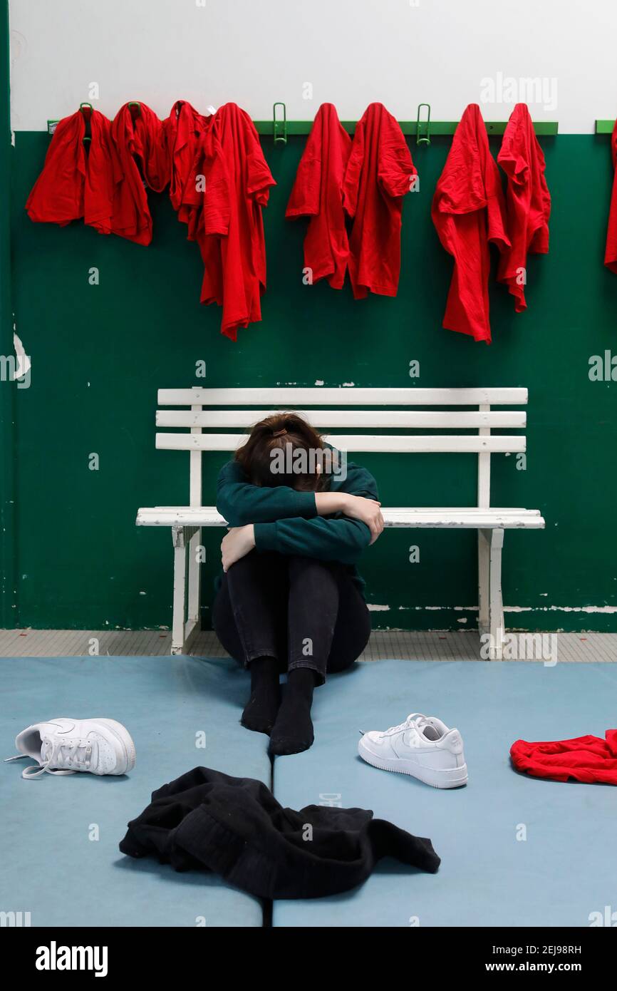 Victim of abuse in a school gym Stock Photo