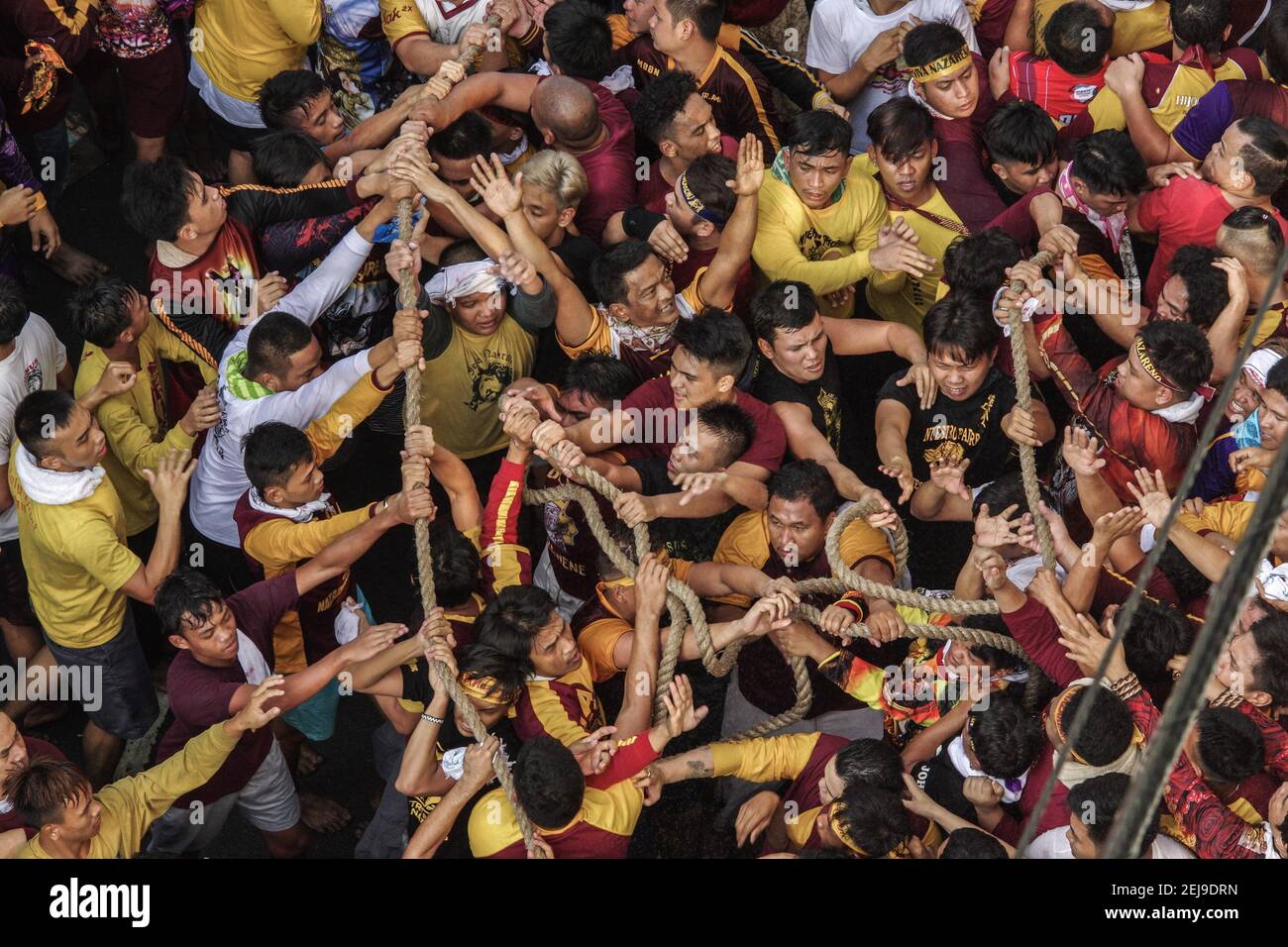 Barefooted devotees pull the rope of the Black Nazarene's carriage as ...