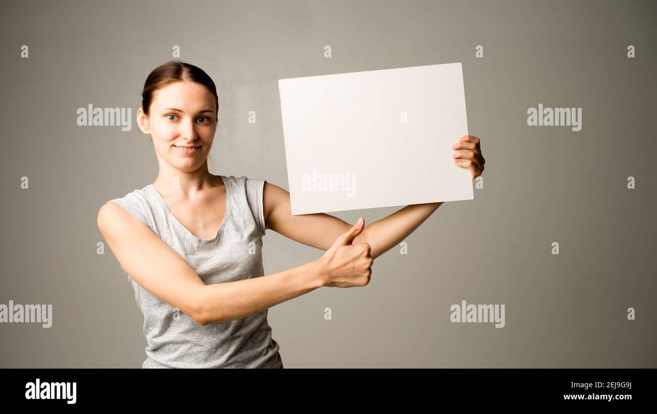 woman holding a sheet of paper in her hand Stock Photo - Alamy