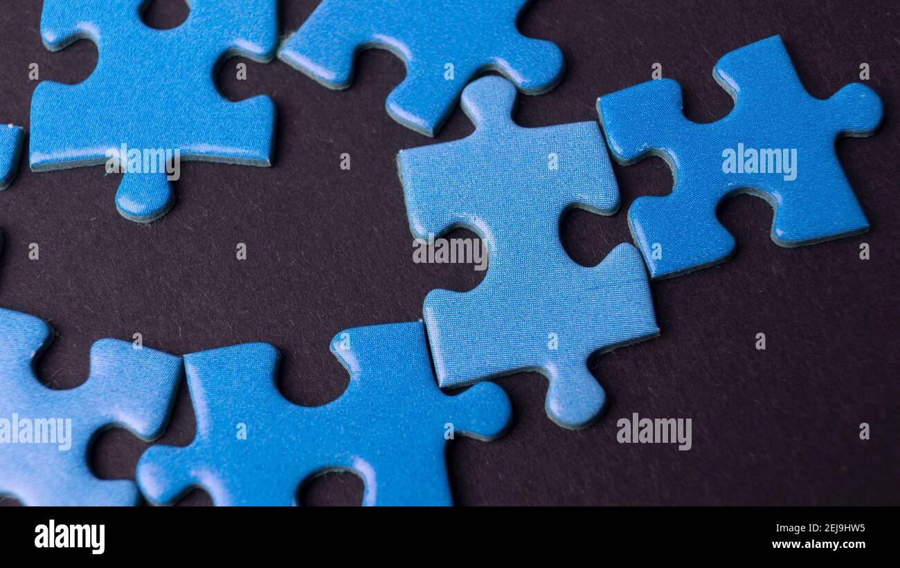 scattered puzzle pieces on colored background Stock Photo