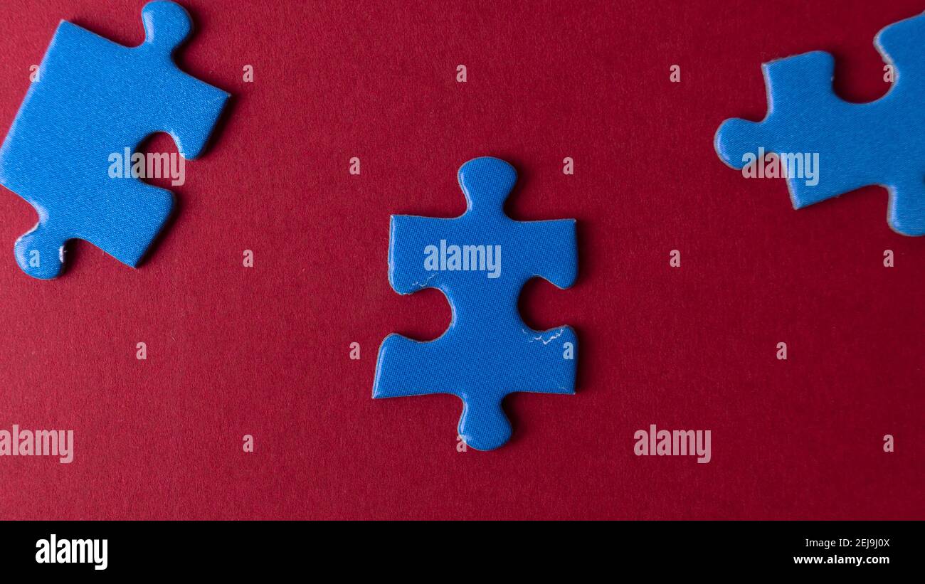 scattered puzzle pieces on colored background Stock Photo