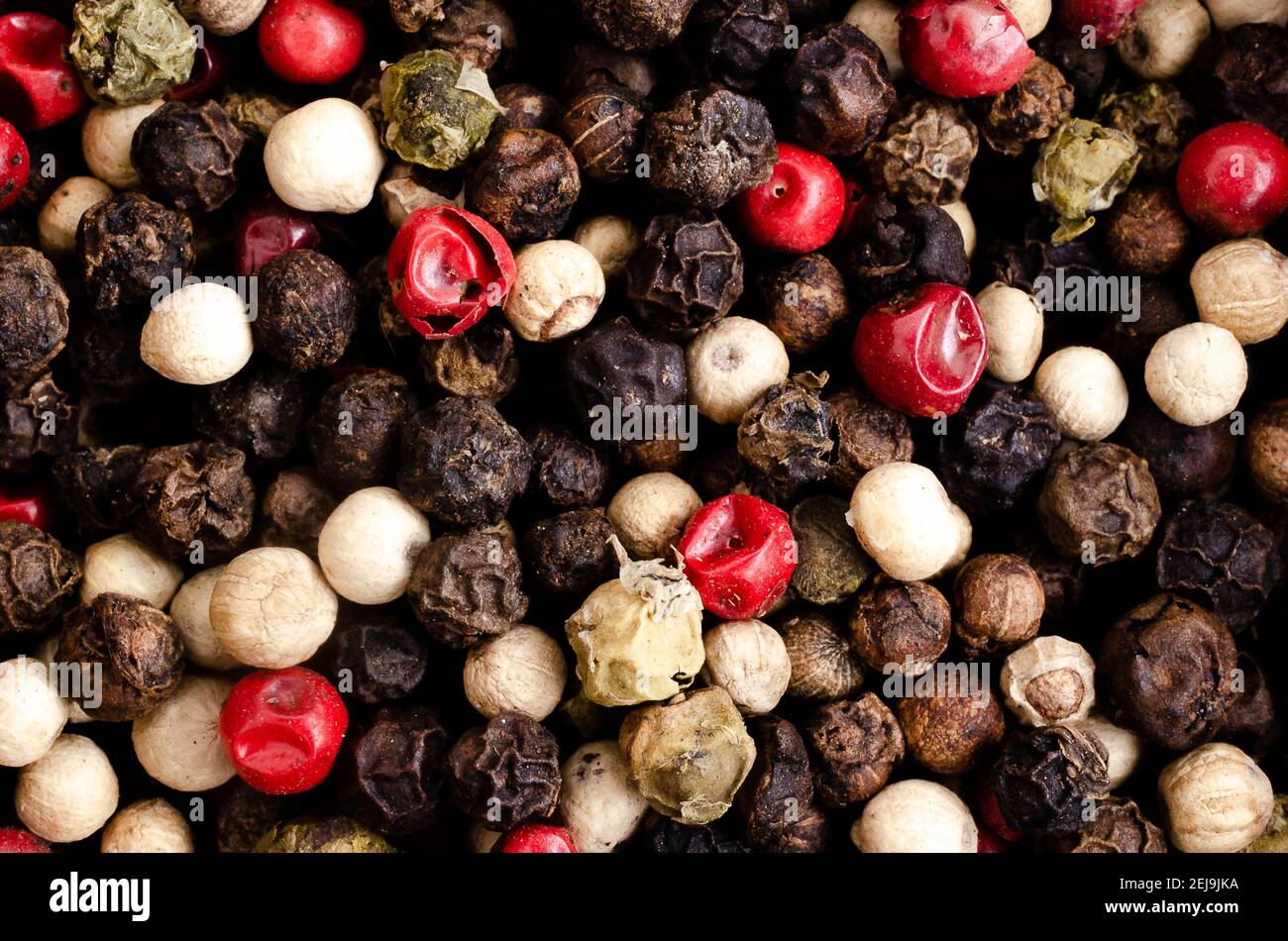 Black, white, green, and pink peppercorns. Stock Photo