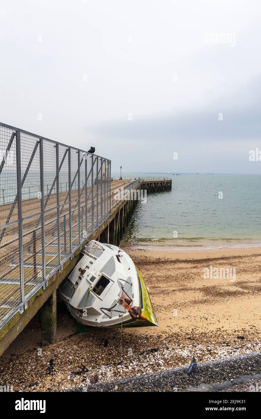 Derelict Yacht Abandoned on Beach at Shoeburyness Against Old
