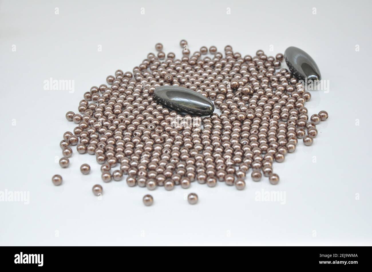 two oval with bijouteral balls beside on white