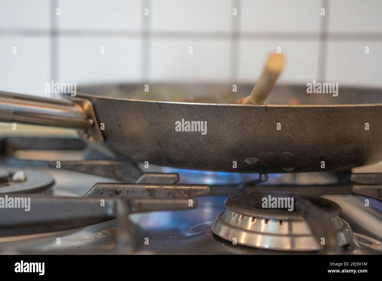 Pan cooking food on a gas stovetop Stock Photo Alamy