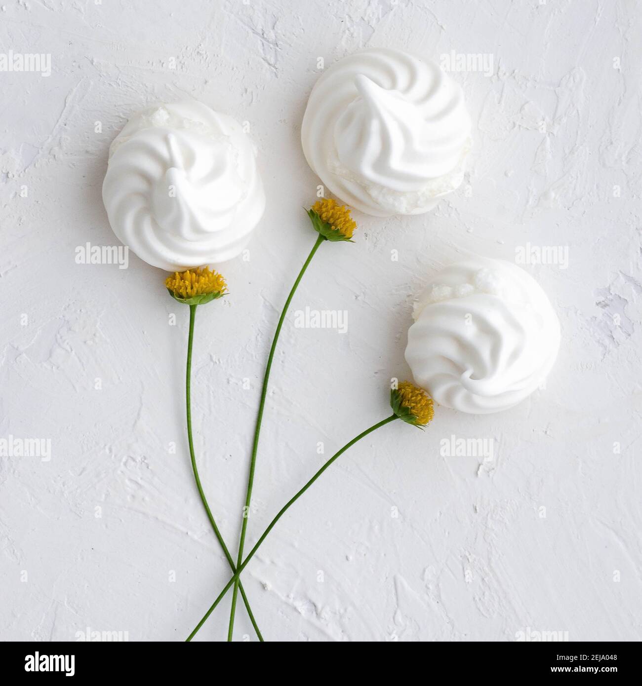 White meringue flowers bouquet on a white backdrop. Top view. Stock Photo