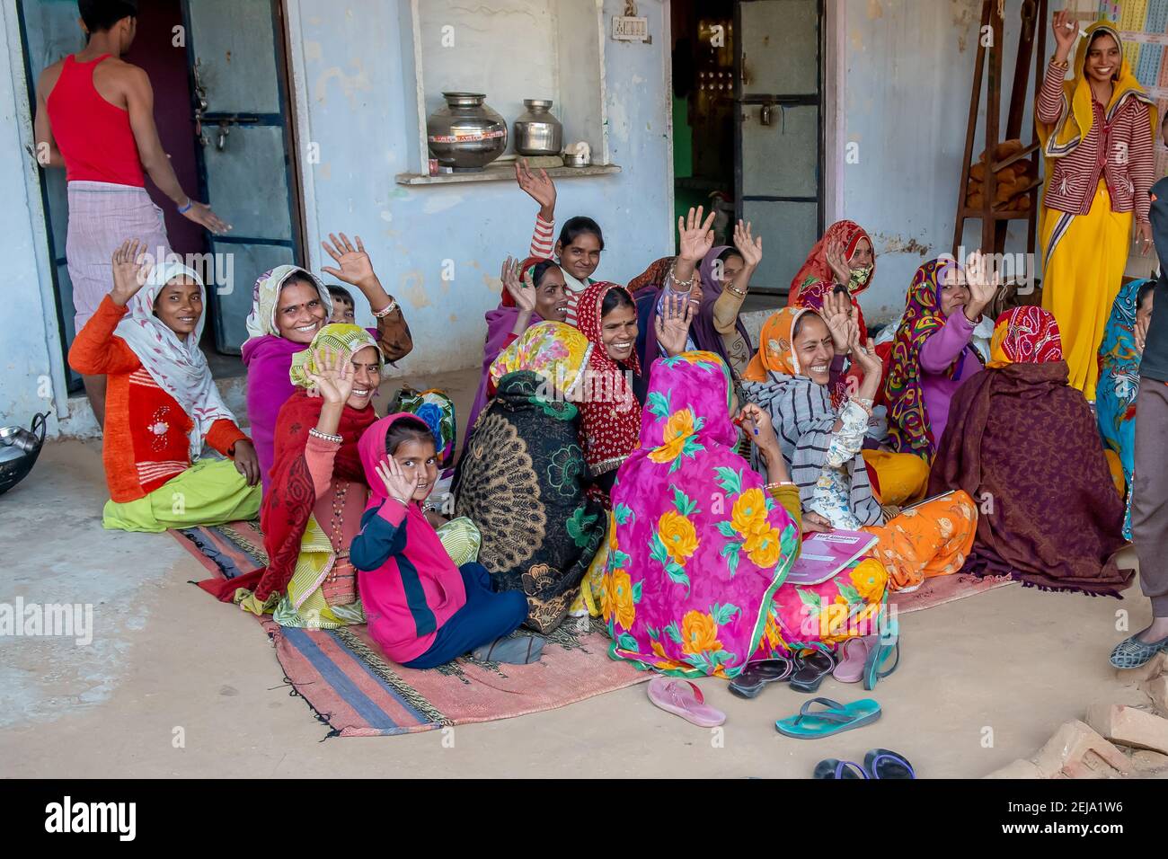 Uttar Pradesh. 05-15-2018. Women working in the textile industry wave goodbye happily. Women apart of taking care of children, they have an important Stock Photo