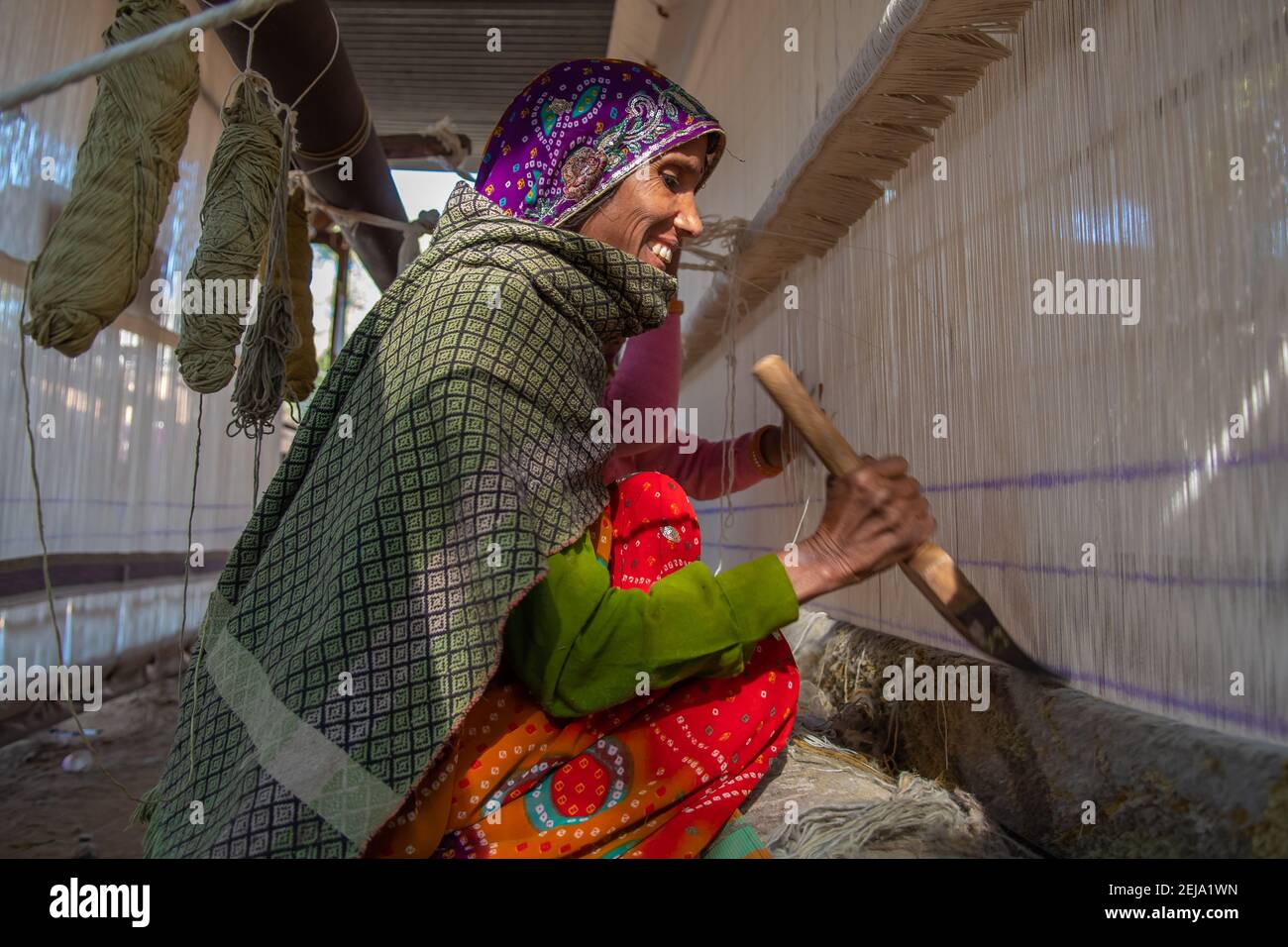 Uttar Pradesh. 05-15-2018. Women working with yarn in the textile industry. Women apart of taking care of children, they have an important role financ Stock Photo