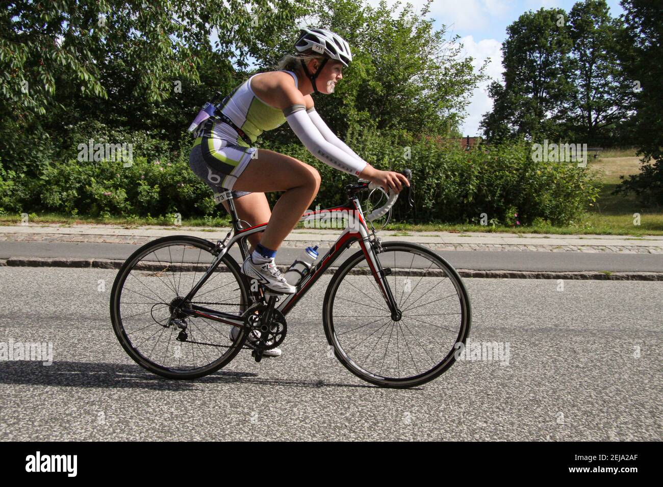 Female racing cyklist on a road bike during triathlon. Side view. Lyngby,  Denmark - June 22, 2014 Stock Photo - Alamy