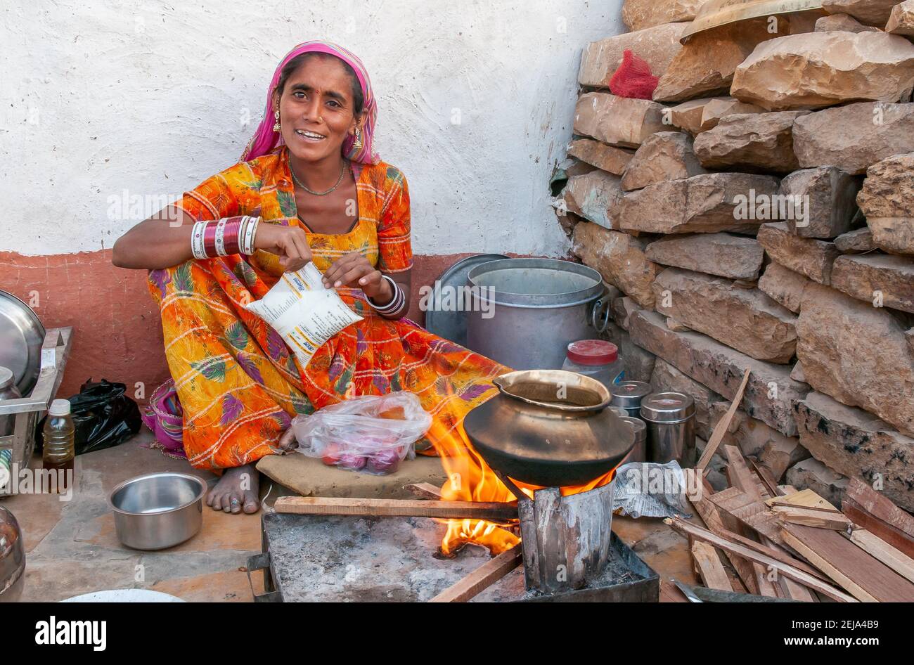 Rajasthan. India. 07-02-2018.Women cooking for children in rural community. Women apart of taking care of children, they have an important role financ Stock Photo
