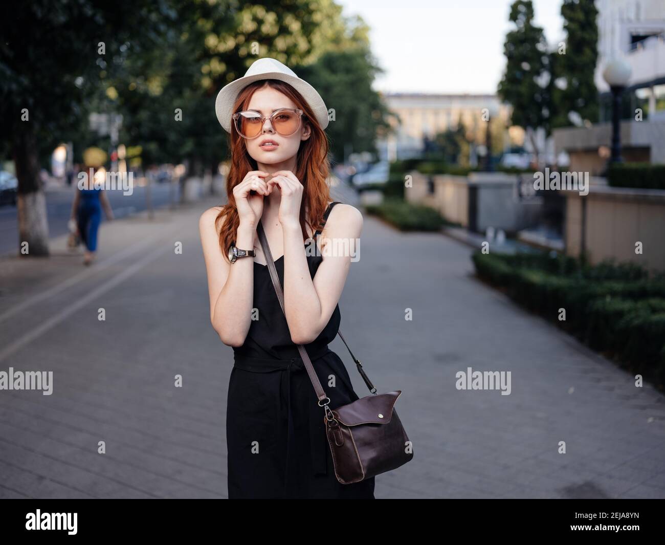 Beautiful woman in black dress walks back hi-res stock photography and ...
