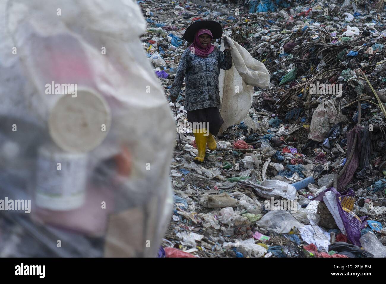 A scavenger looks for used plastic bottles at a landfill in Lhokseumawe,  Aceh province. The World Bank report shows that around 105 thousand metric  tons of municipal waste are produced in Indonesia