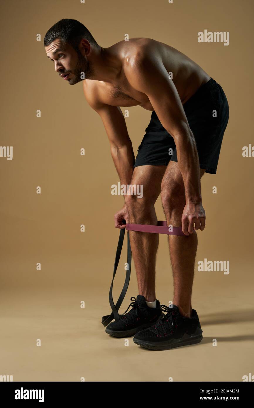 Full length side view portrait of strong adorable Caucasian sportsman ...