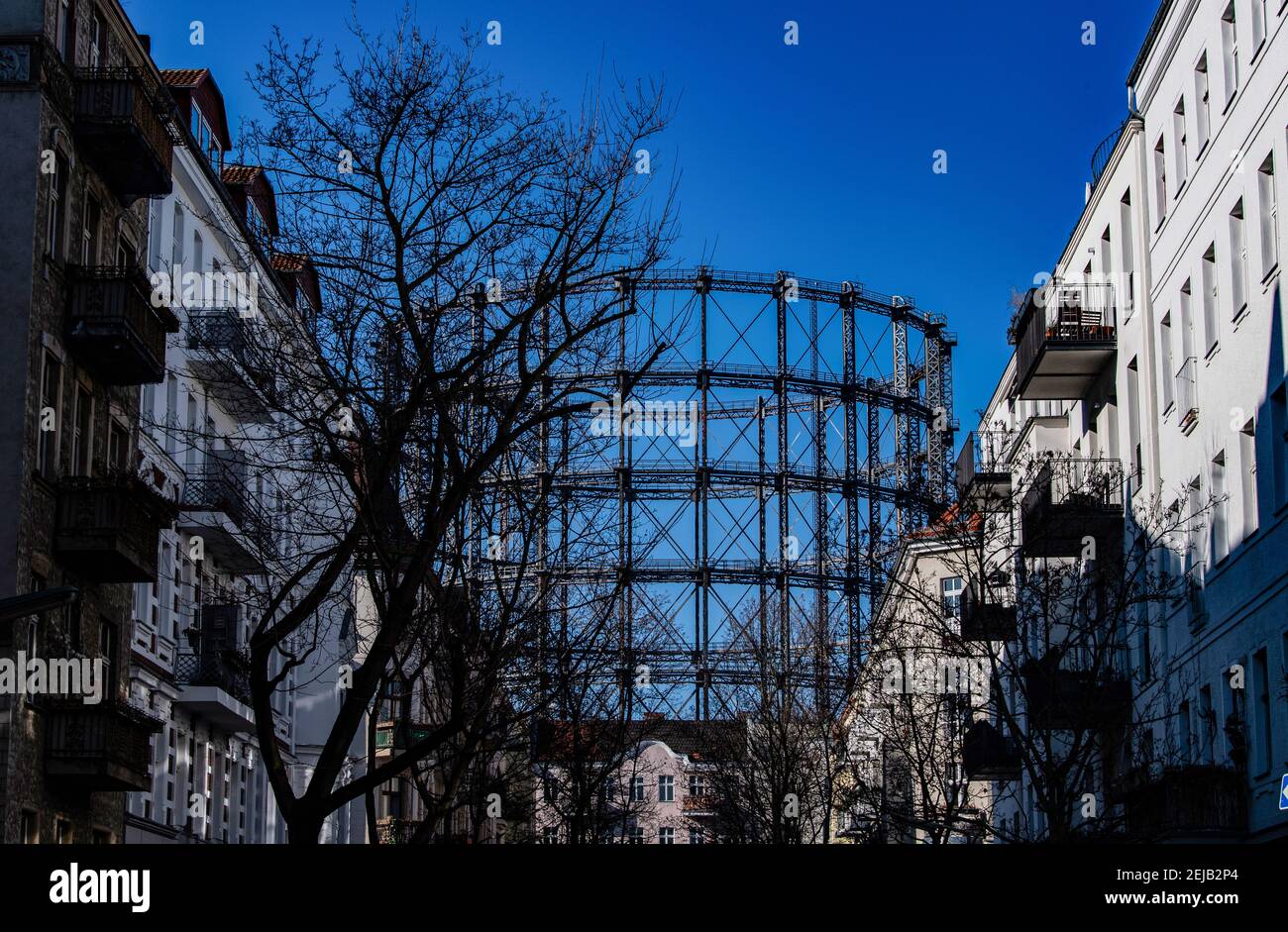 Berlin, Germany. 22nd Feb, 2021. The gasometer in Schöneberg can be seen between residential buildings. The participation procedure for the conversion of the listed Gasometer ends on 24 February. If the owner has his way, the over 100-year-old steel construction is to be given a new lease of life as the shell of an office building. However, a citizens' initiative wants to prevent this and is calling for signatures on a petition. Credit: Paul Zinken/dpa-Zentralbild/dpa/Alamy Live News Stock Photo