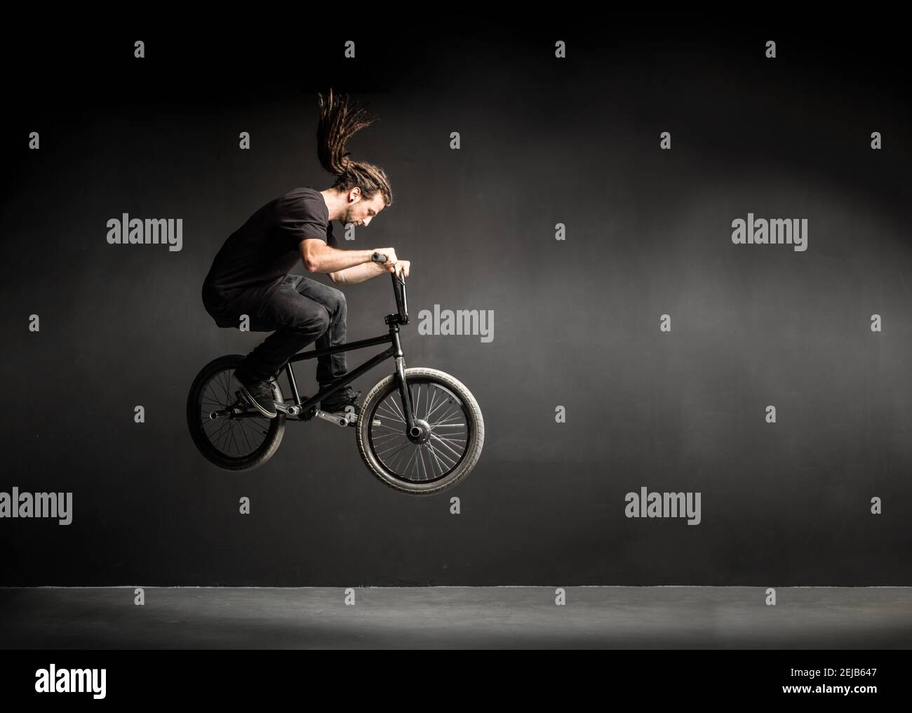 Young man doing a stunt on his BMX bicycle. Professional sportsman. Stock Photo