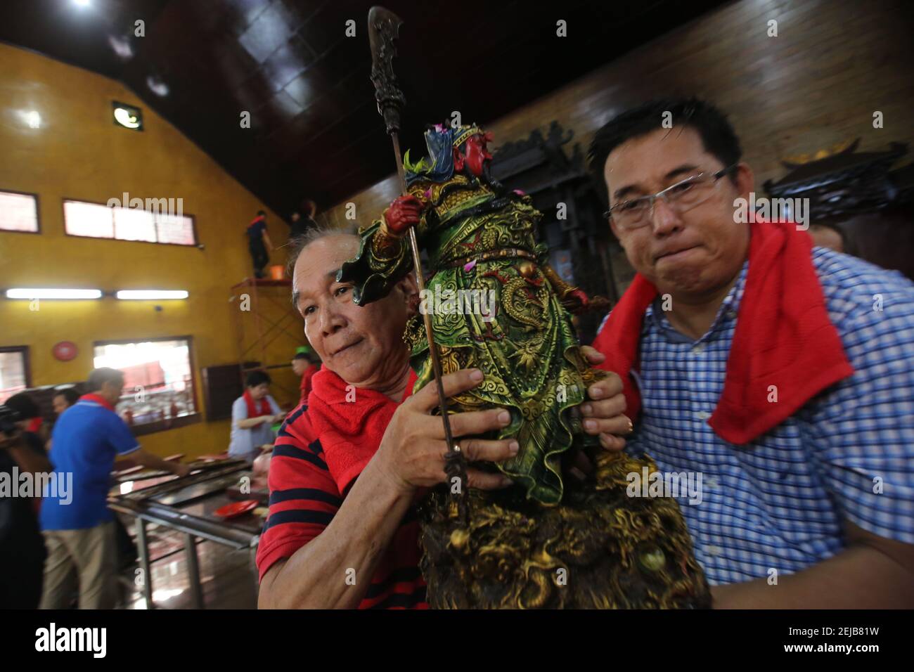 Men carry a statue during the celebration at the Amurva Bhumi temple in