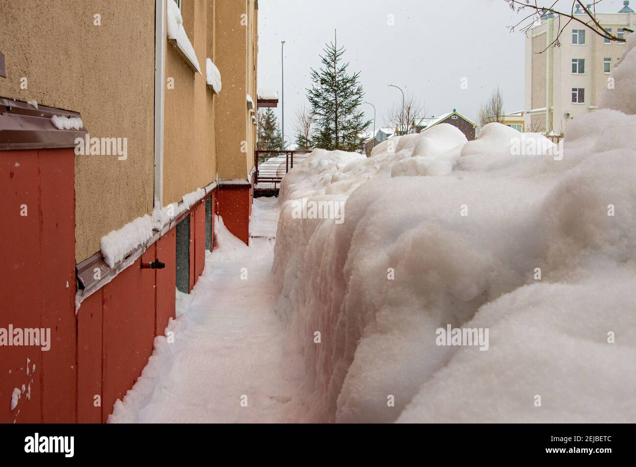 digging out walls of houses from snow in the spring, at the end of winter Stock Photo