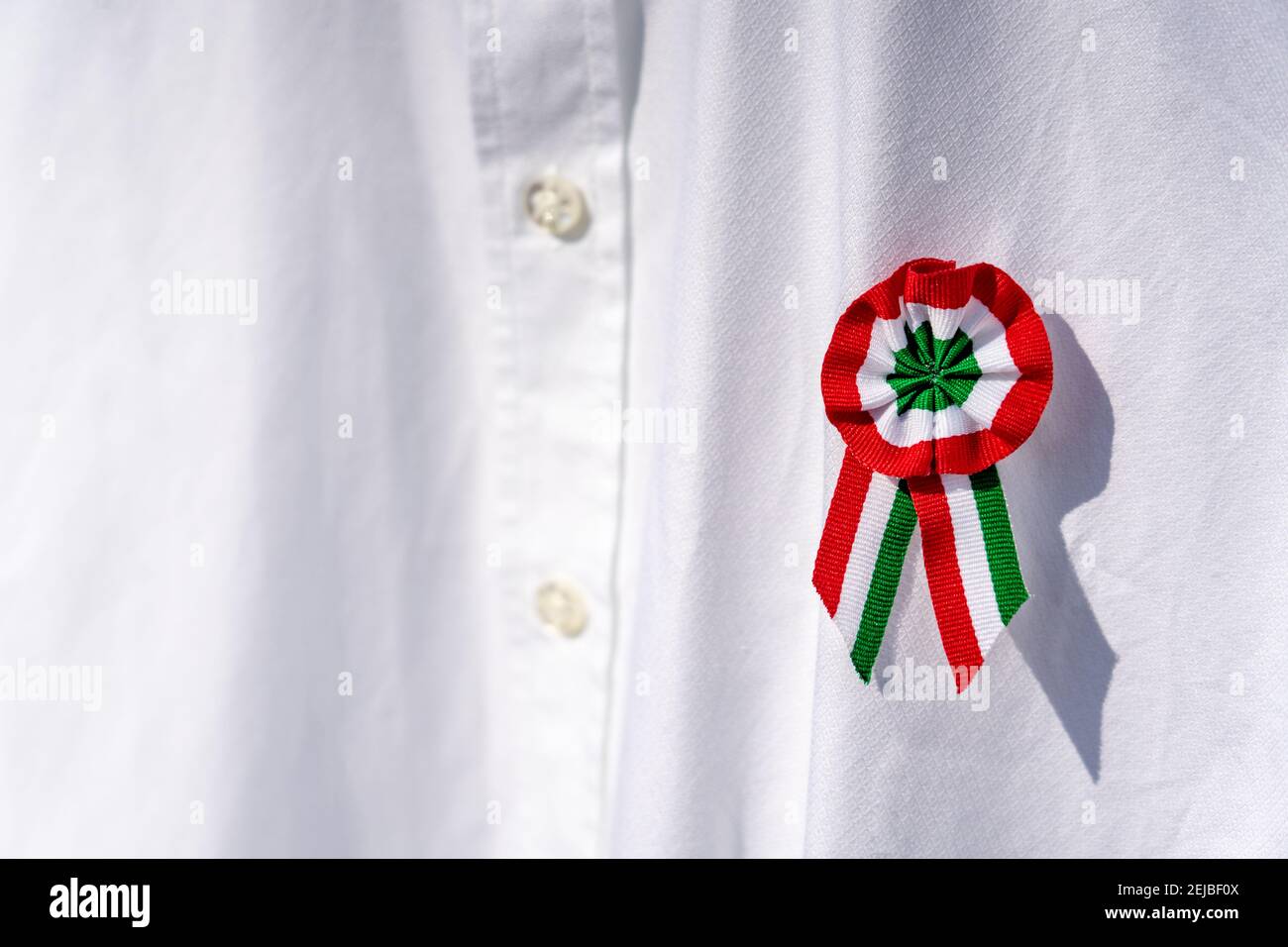 close up white shirt with tricolor rosette symbol of the hungarian