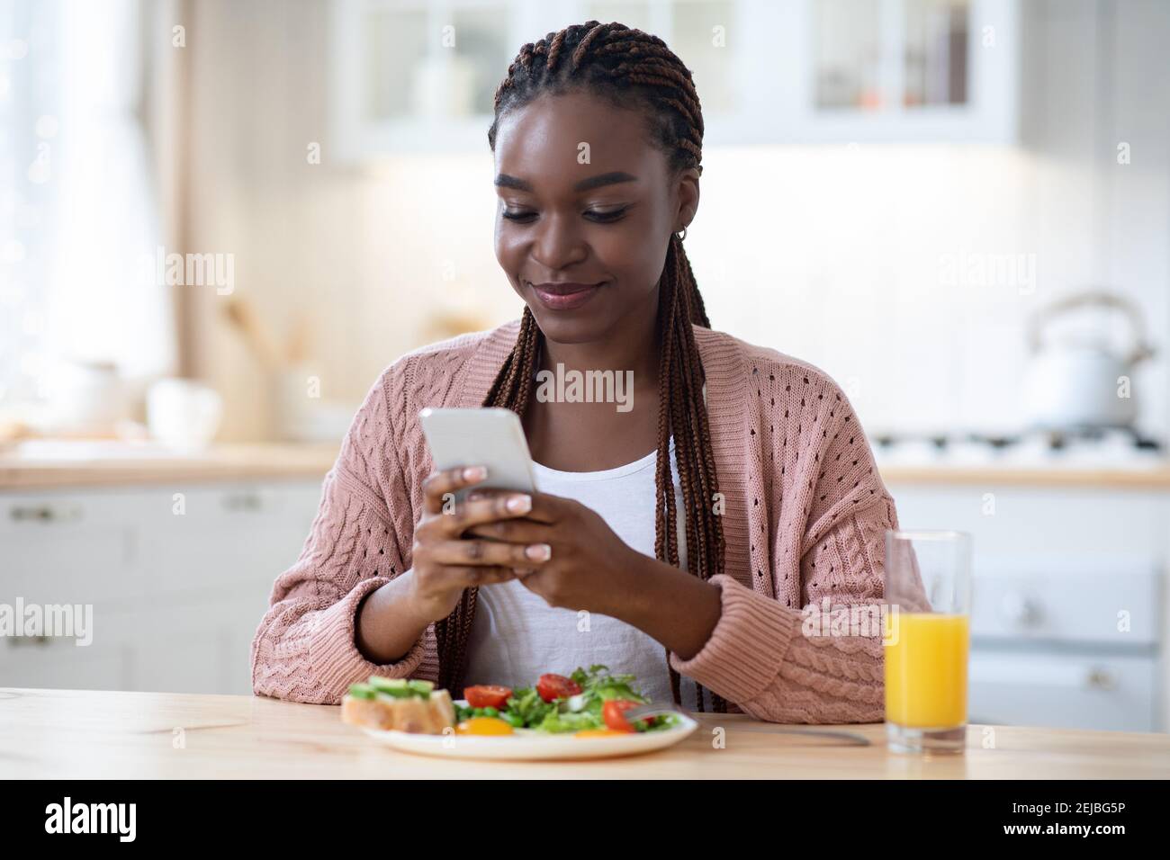 Smiling black woman having breakfast hi-res stock photography and ...