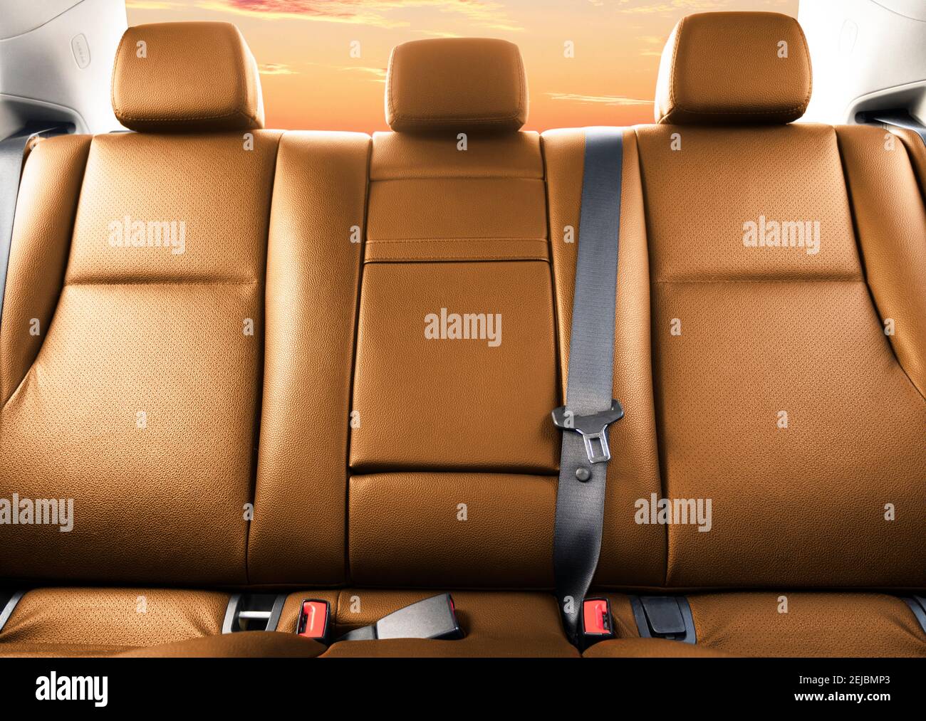 Back passenger brown leather seats in modern luxury car. Orange