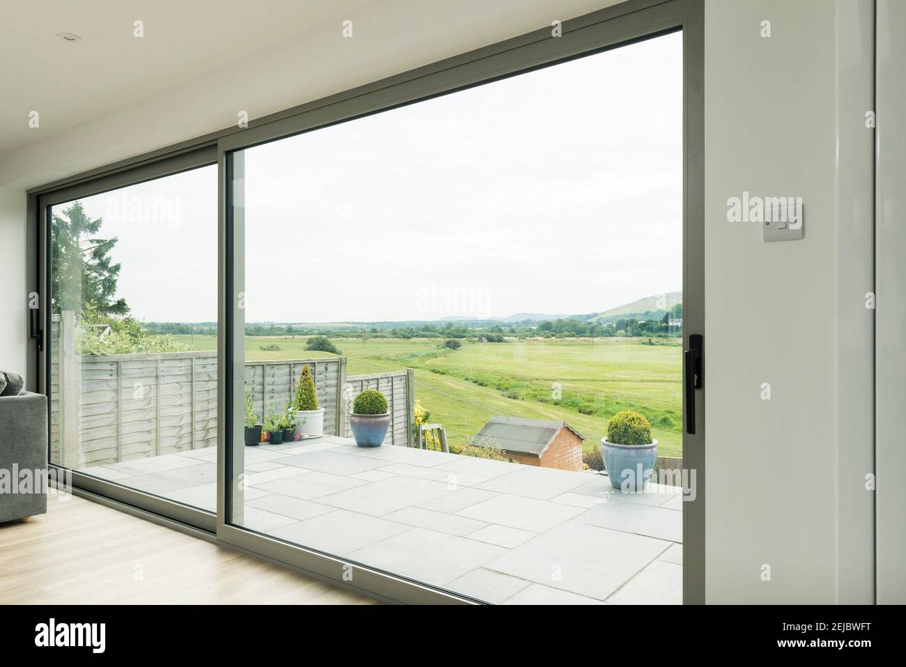 Very big sliding patio double glazed doors opening into a garden Stock