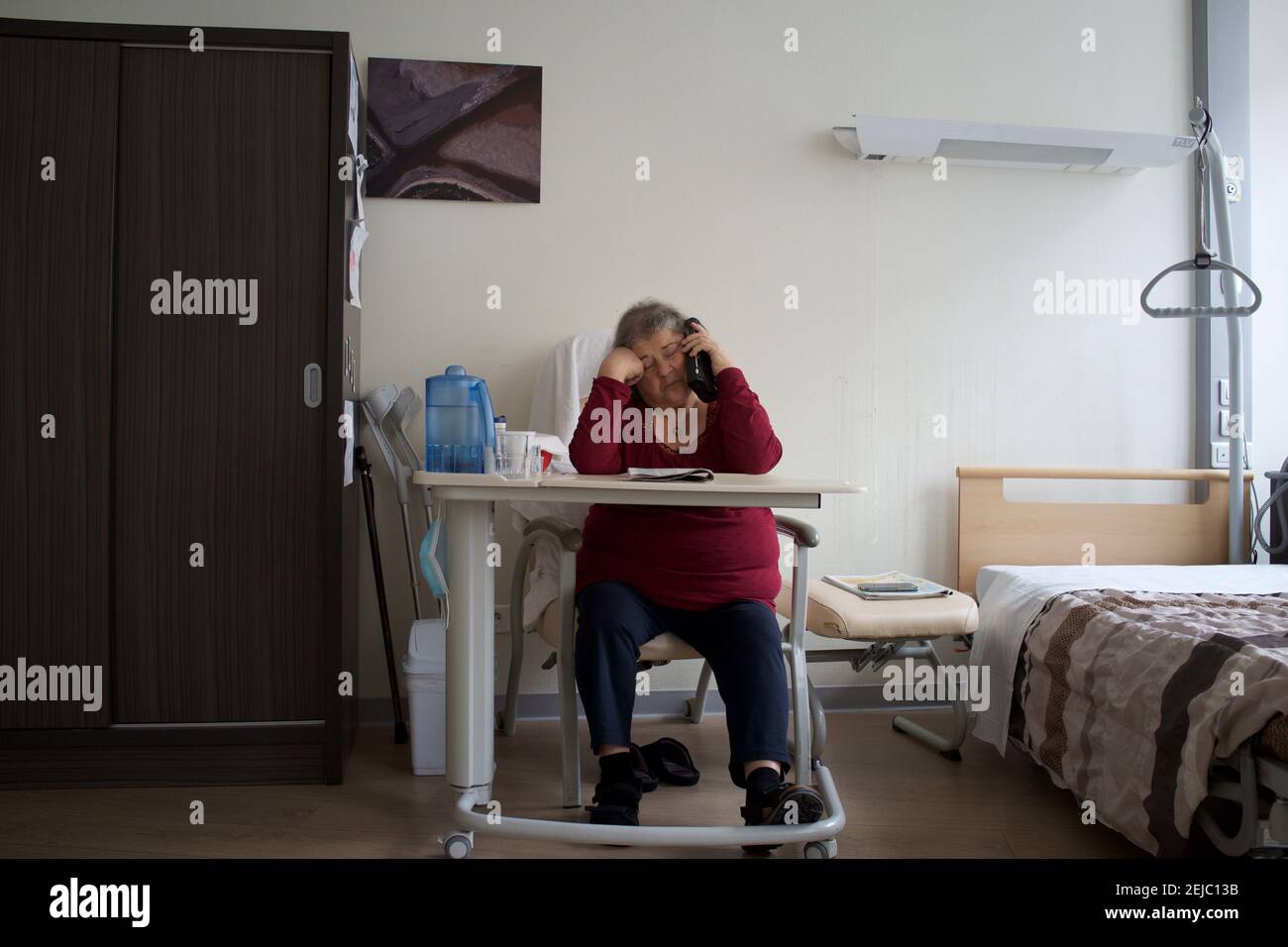 Patient in room, listening to radio, residential care home - Paris, France Stock Photo