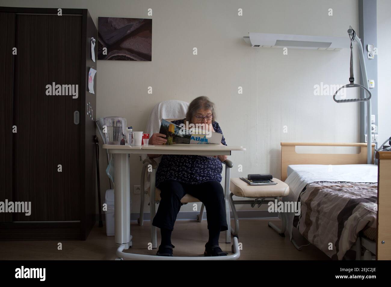 Patient in room, reading, residential care home - Paris, France Stock Photo