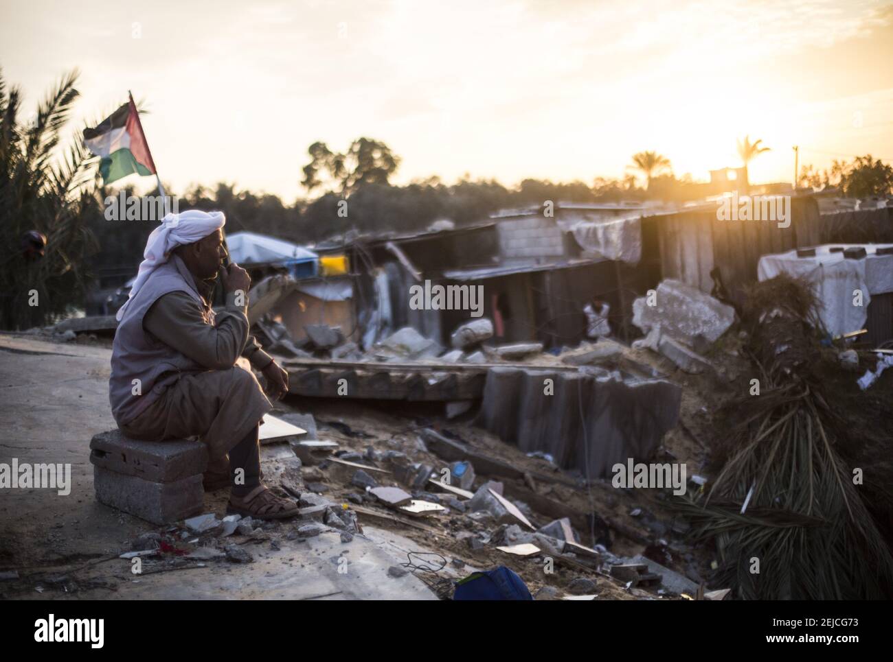 Hassan Hamouda Abu Amra stares at the rubble of his destroyed house