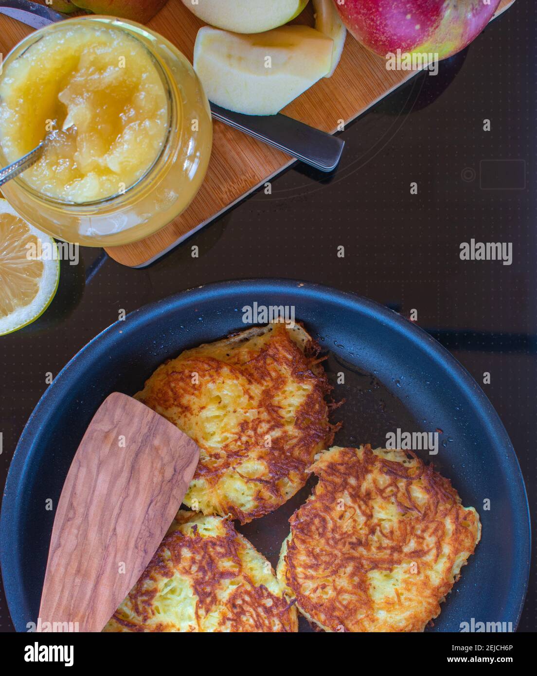 fresh fried potato pancakes on a stove with apple sauce Stock Photo