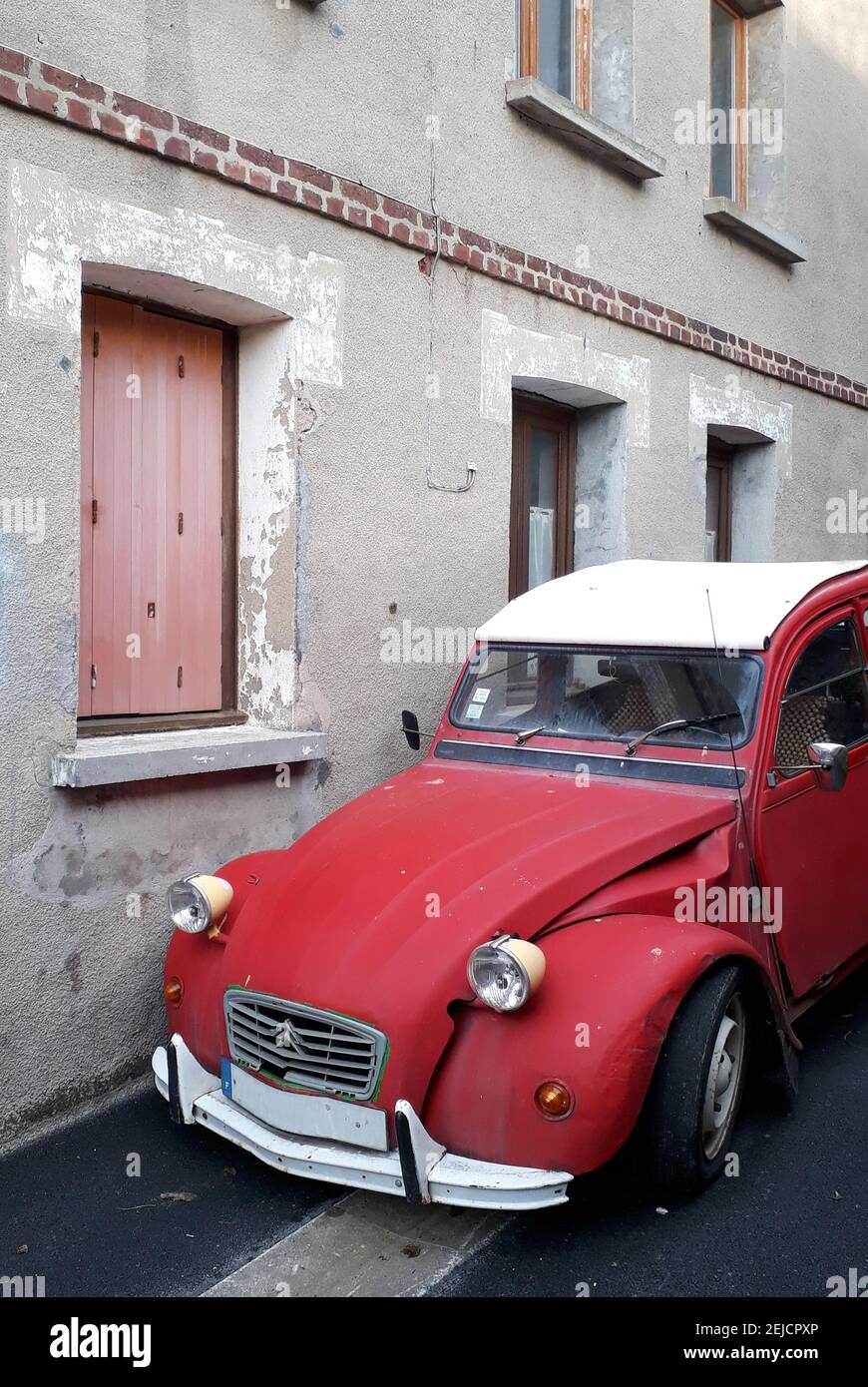 2cv, red classic car in front of a wall in Yport, Normandy, France Stock Photo