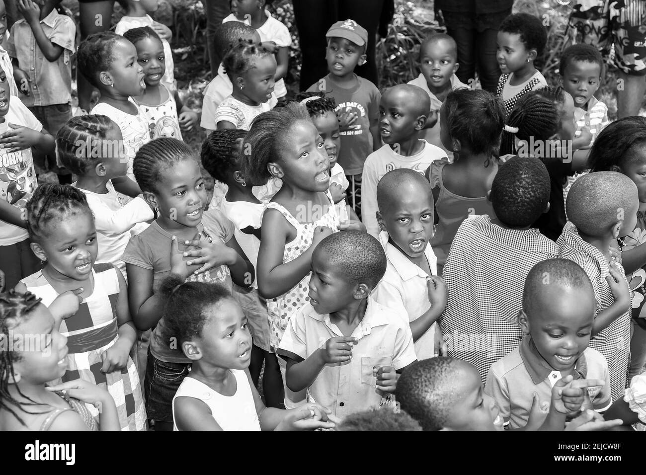 JOHANNESBURG, SOUTH AFRICA - Feb 20, 2021: Soweto, South Africa - November 16, 2012: Young African Preschool kids singing songs in the playground of a Stock Photo