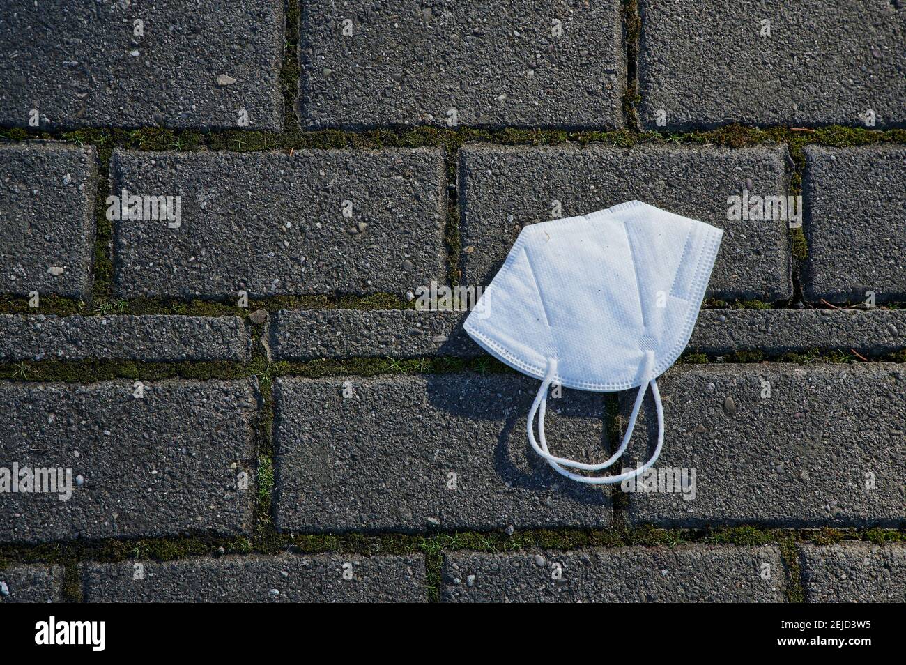 a lost FFP 2 mask lying on the pavement in Germany Stock Photo