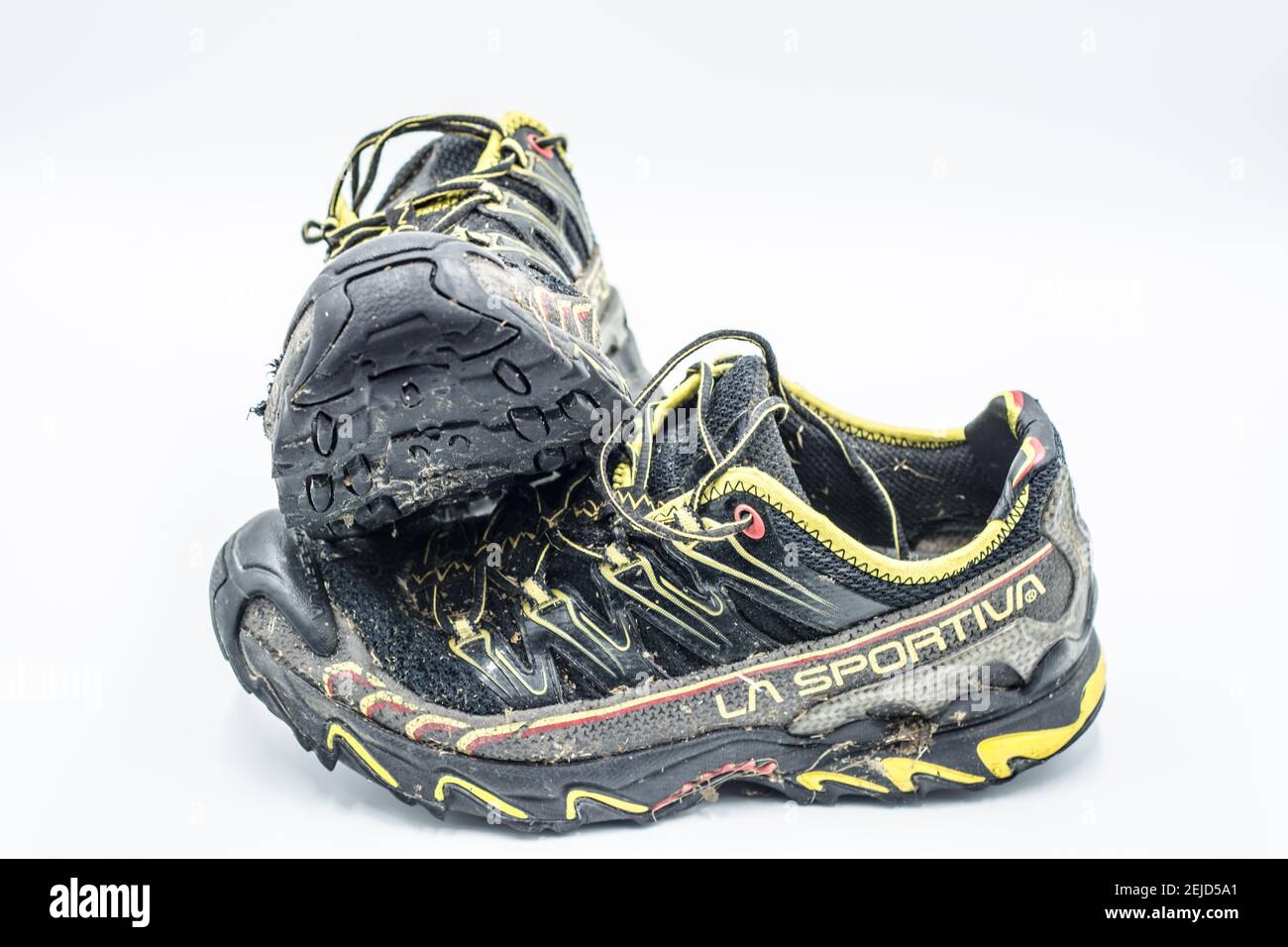 Dirty trail running shoes over white background Stock Photo - Alamy