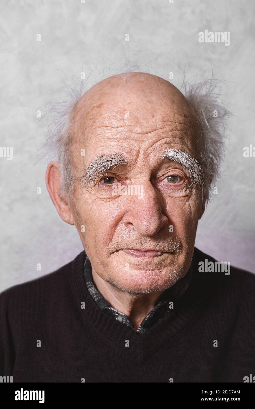 Elderly man portrait. Close up. Glaucoma in left eye. Getting Old concept. Amazingly beautiful old man. Kindness in eyes. Retired.  Stock Photo