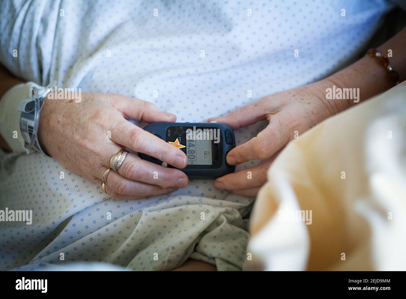 https://c8.alamy.com/comp/2EJD9MM/patient-adjusting-the-intensity-of-her-implanted-spinal-cord-stimulator-to-combat-pain-2EJD9MM.jpg