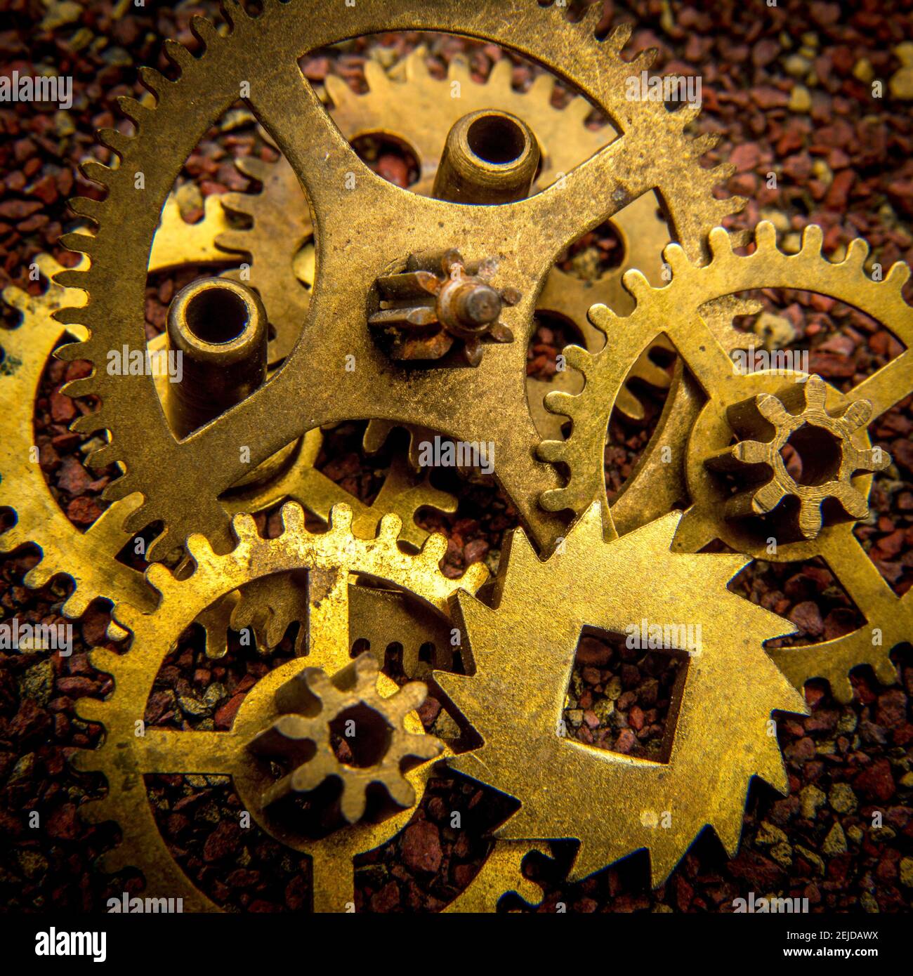 Intricate arrangement of vintage brass gears on textured surface in ...