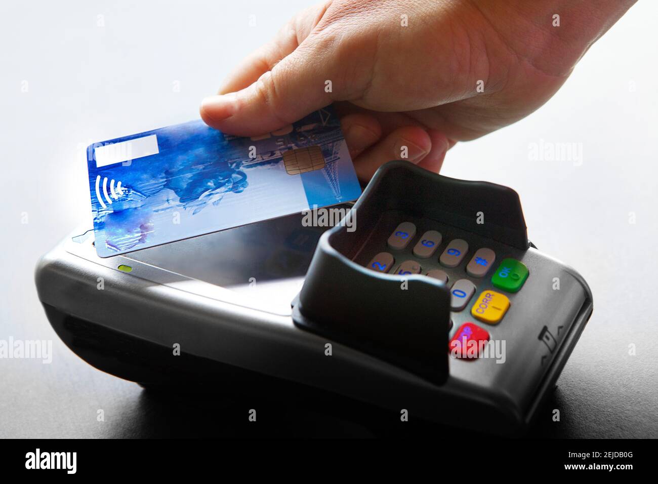 Woman paying with a contactless bank card. Stock Photo