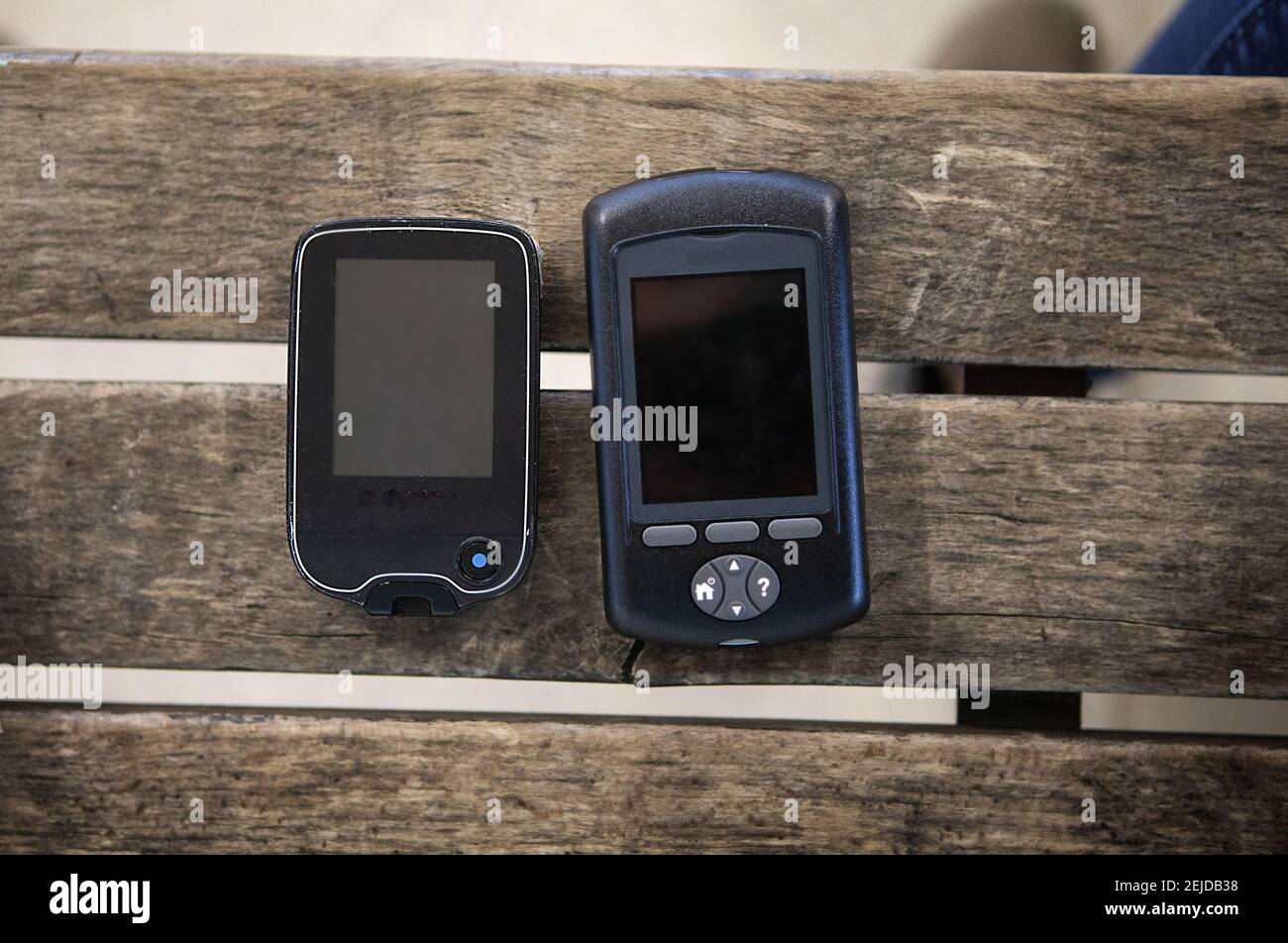 Blood glucose sensor for controlling blood sugar and an insulin pump for delivering insulin. Stock Photo
