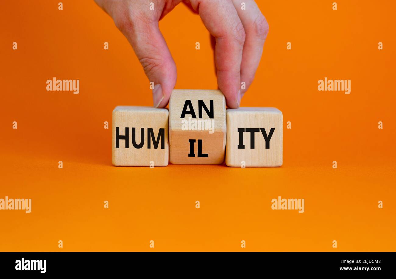 Humility Cube Humility vs humanity symbol. Businessman turns cubes and changes the ...