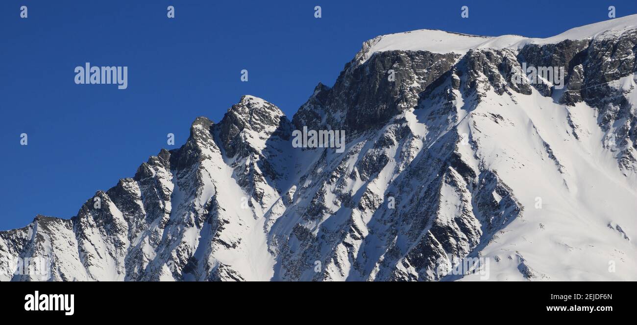 Snow covered rugged mountain seen from Elm, Switzerland. Stock Photo