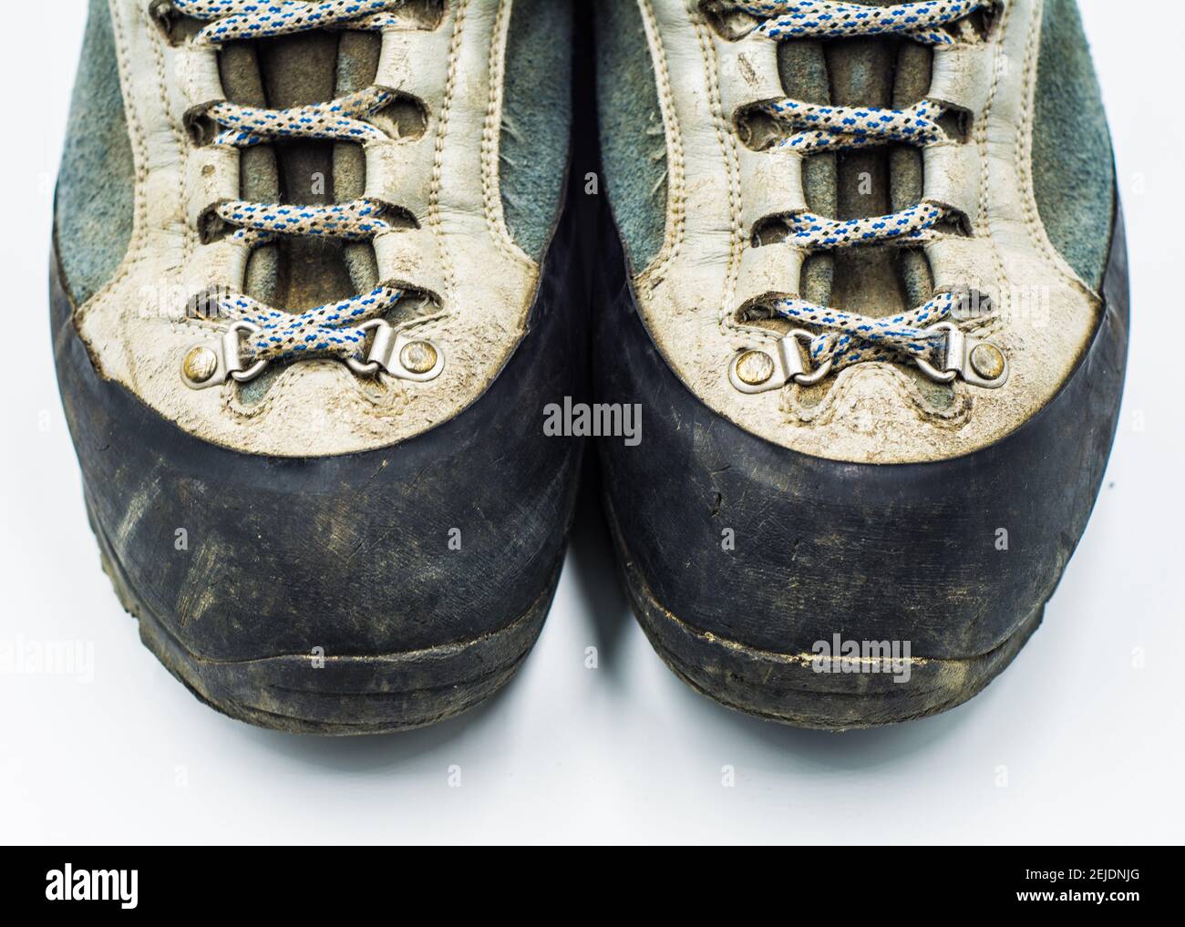 Old scuffed hiking boots isolated on white background Stock Photo