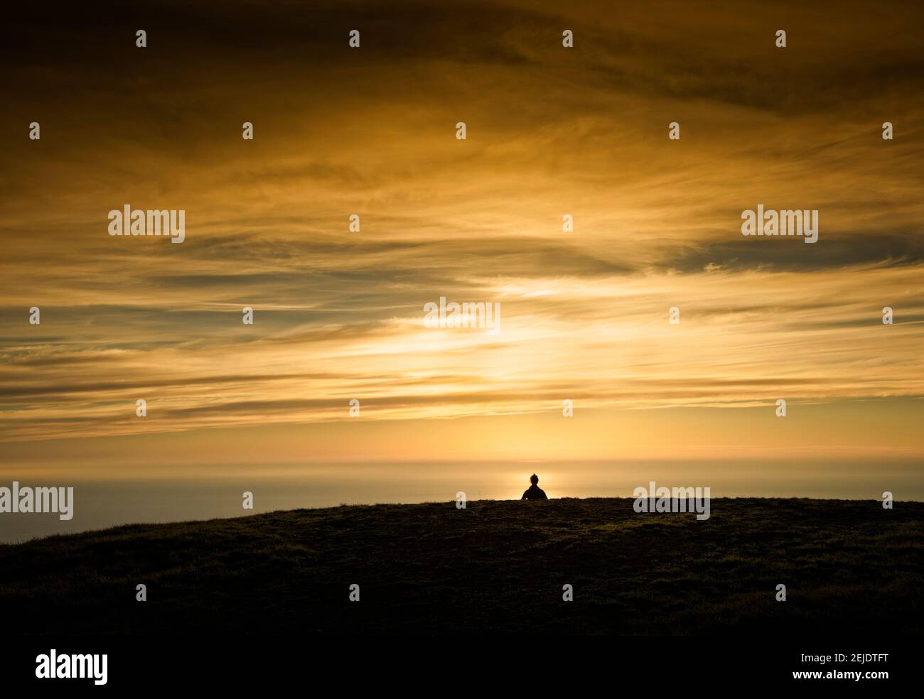 Silhouette of a woman meditating on top of a mountain, California, USA ...