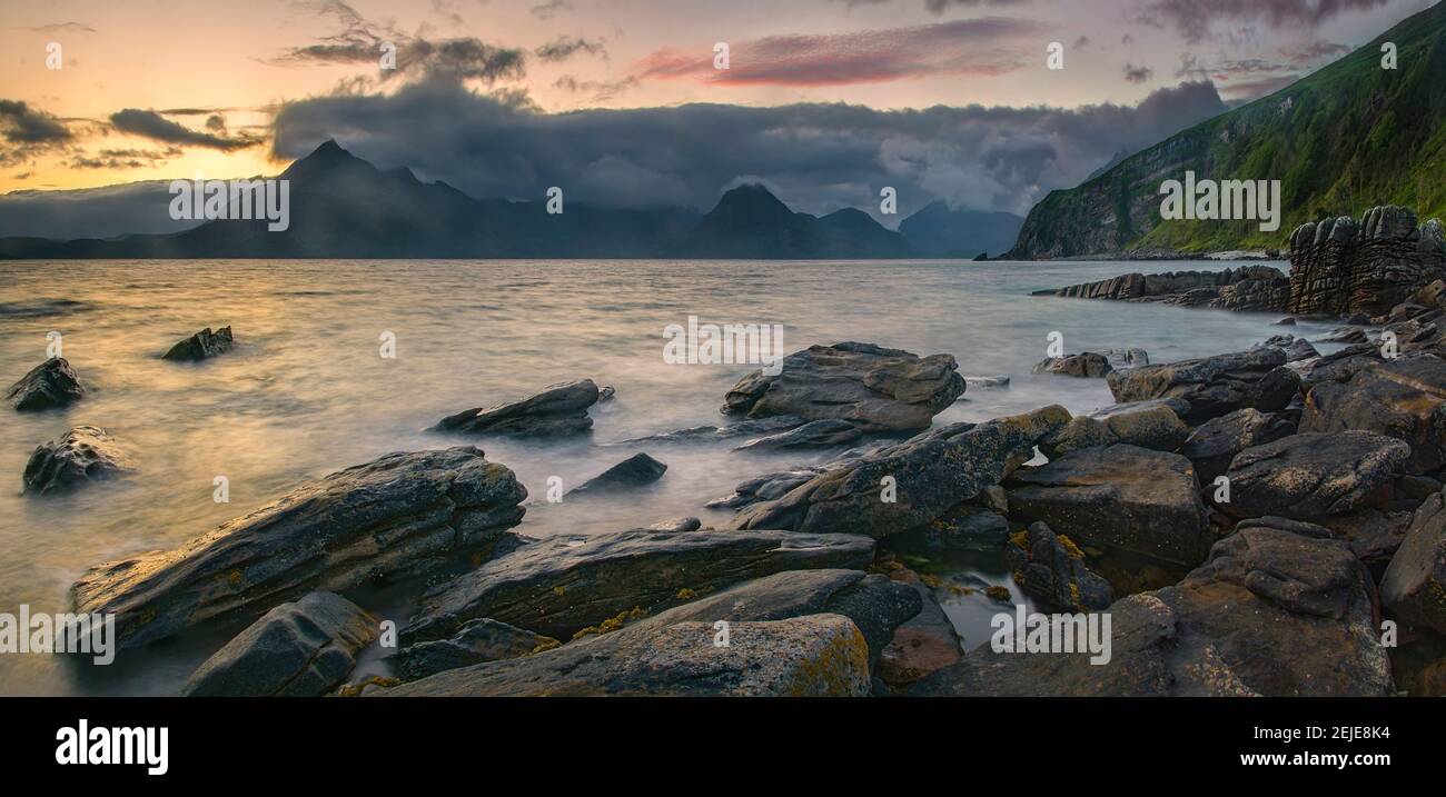 Rocky coast of Loch Scavaig with Cuillin mountains at sunset, Isle of Skye, Scotland Stock Photo