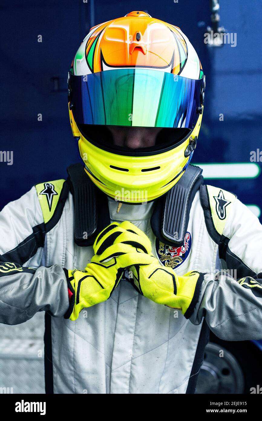 young male car racer with a helmet. racing driver wearing crash helmet Stock Photo