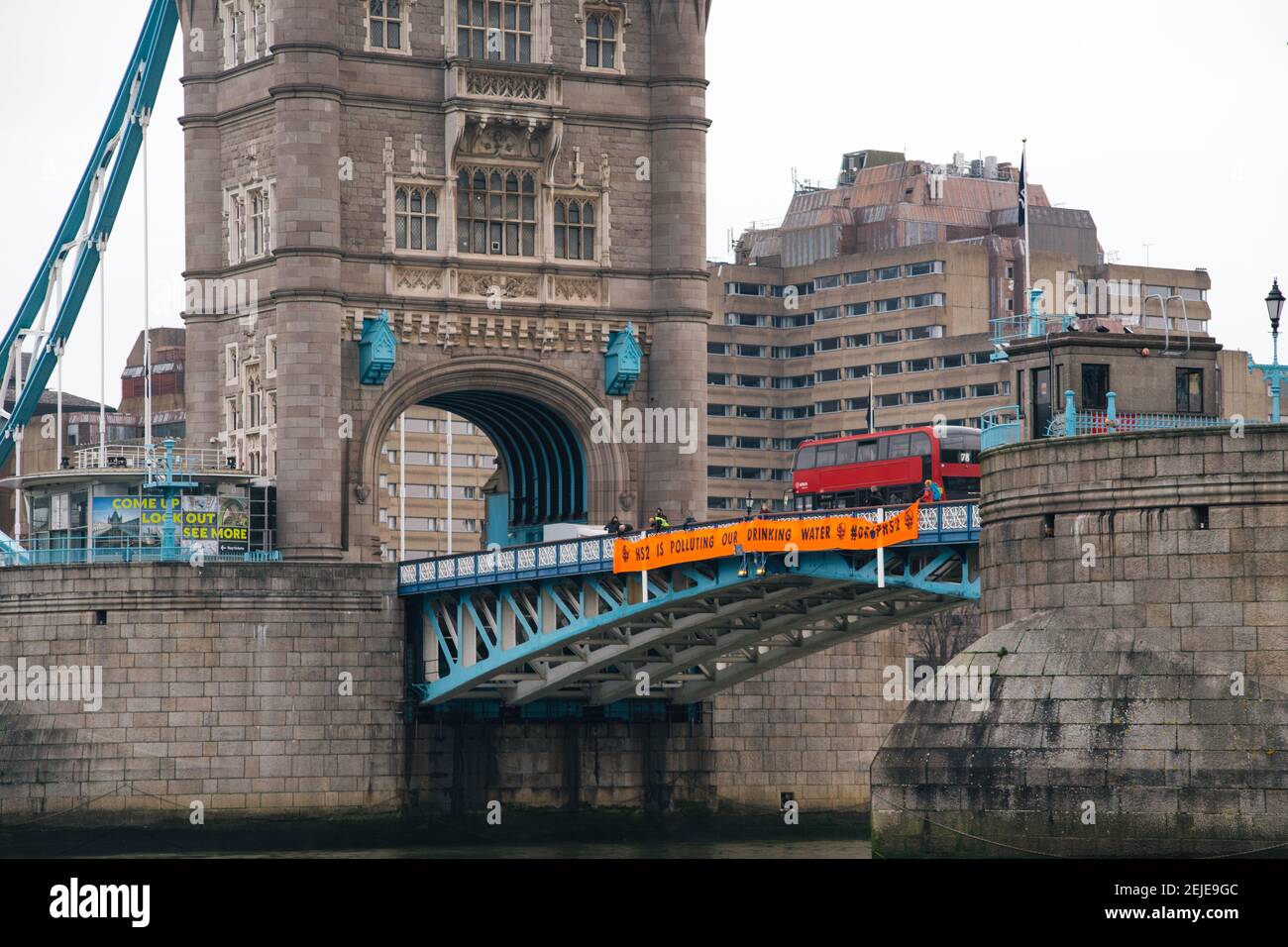 London, UK. 22nd Feb, 2021. Anti HS2 protestors hang a banner from Tower Bridge calling on the government to stop the HS2 project. Credit: Denise Laura Baker/Alamy Live News Stock Photo