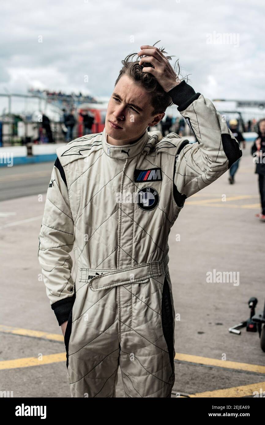 Young racing car driver on a track. Stock Photo