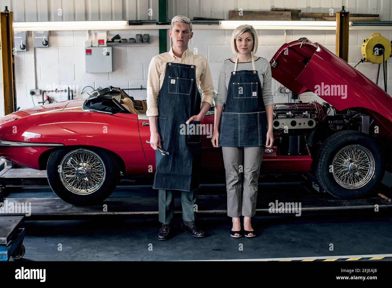 auto mechanic couple stands in garage Stock Photo